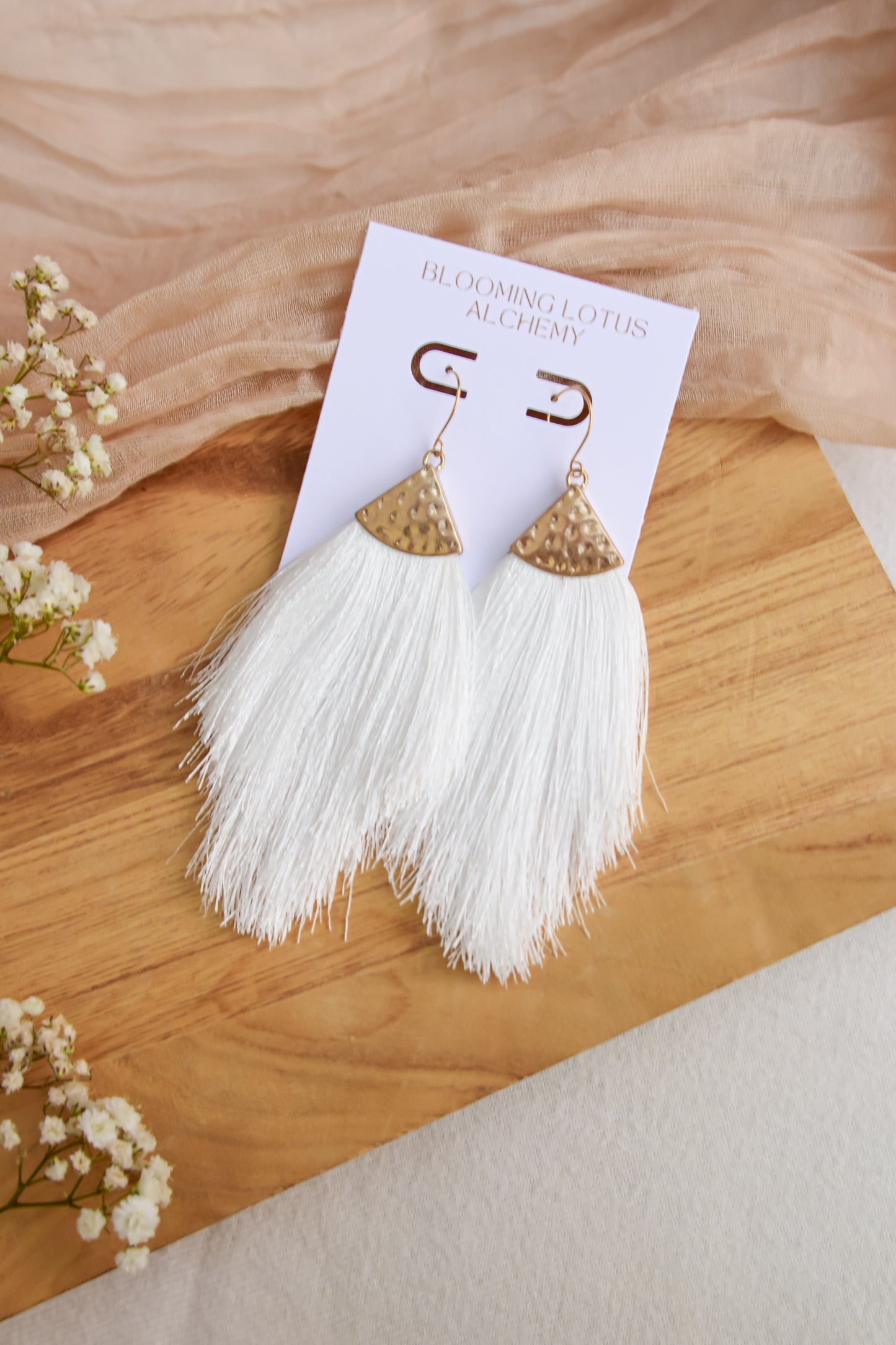 White Tassel Earnings